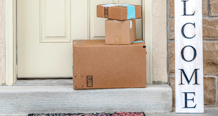 Packages on the doorstep of a home with a welcome sign in South Bend